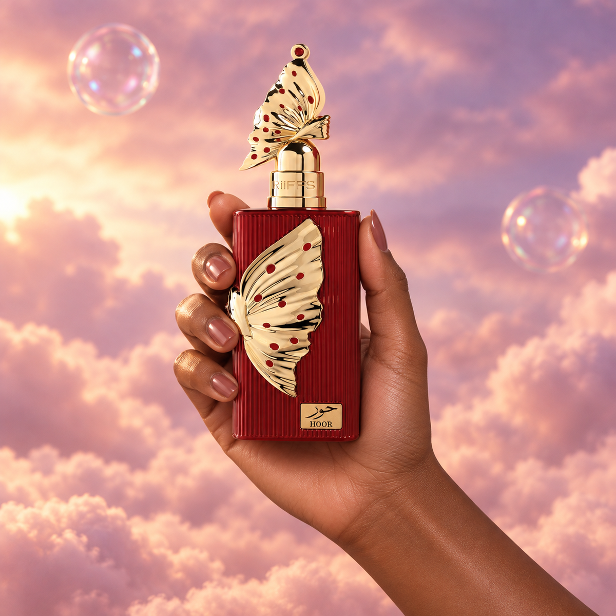 A hand holds the bottle of Hoor by Riiffs among pink clouds.