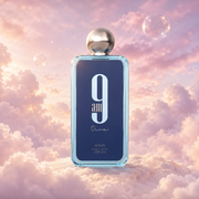 Bottle of 9 AM Dive by Afnan on a bank of clouds, in a pink and lavender sky with iridescent bubbles and golden light.
