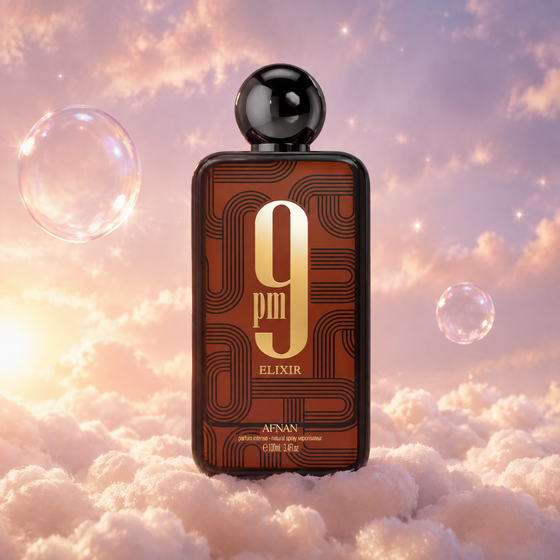 Bottle of 9 PM Elixir by Afnan on a bank of clouds, in a pink and lavender sky with iridescent bubbles and golden light.