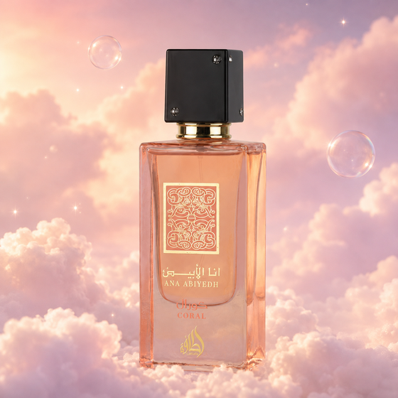 Bottle of Ana Abiyedh Coral by Lattafa on a bank of clouds, in a pink and lavender sky with iridescent bubbles and golden light.