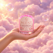 The Blush Amber Aura candle in hand, to show its size