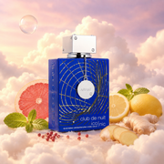 The bottle of Club de Nuit Blue Iconic by Armaf surrounded by grapefruit, lemon, ginger and melon, on clouds.
