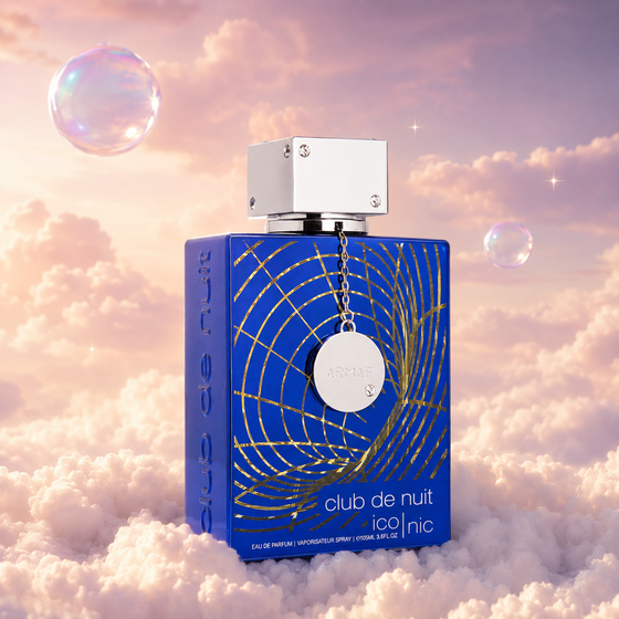 Bottle of Club de Nuit Blue Iconic by Armaf on a bank of clouds, in a pink and lavender sky with iridescent bubbles and golden light.