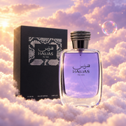 The bottle of Hawas For Him by Rasasi next to its original box, on clouds.