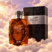 The bottle of Hawas Private Dulce by Rasasi next to its original box, on clouds.