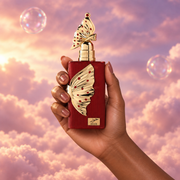 A hand holds the bottle of Hoor by Riiffs among pink clouds.