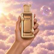 A hand holds the bottle of Jasmere by French Avenue among pink clouds.
