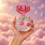 A hand holds the bottle of Layaan by Lattafa among pink clouds.