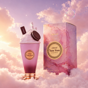 The bottle of Yum Yum by Armaf next to its original box, on clouds.